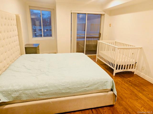 100 Cutter Mill Road, Unit 4G Great Neck, NY 11021 - Photo 9 of 18 Bedroom with wood finished floors and access to outside