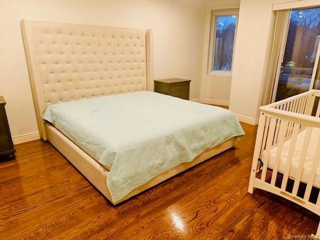 100 Cutter Mill Road, Unit 4G Great Neck, NY 11021 - Photo 10 of 18 Bedroom with wood finished floors and baseboards