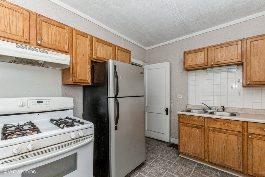 1436 West 110th Place Chicago, IL 60643 - Photo 2 of 10 a kitchen with stainless steel appliances a refrigerator a stove a sink and cabinets