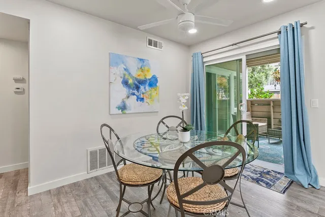 a view of a dining room with furniture a chandelier and wooden floor