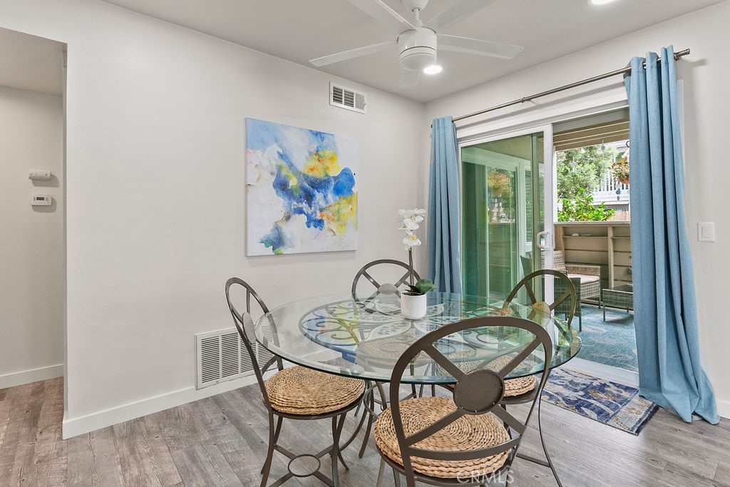 34110 Selva Road, Unit 328 Dana Point, CA 92629 - Photo 11 of 33 a view of a dining room with furniture a chandelier and wooden floor