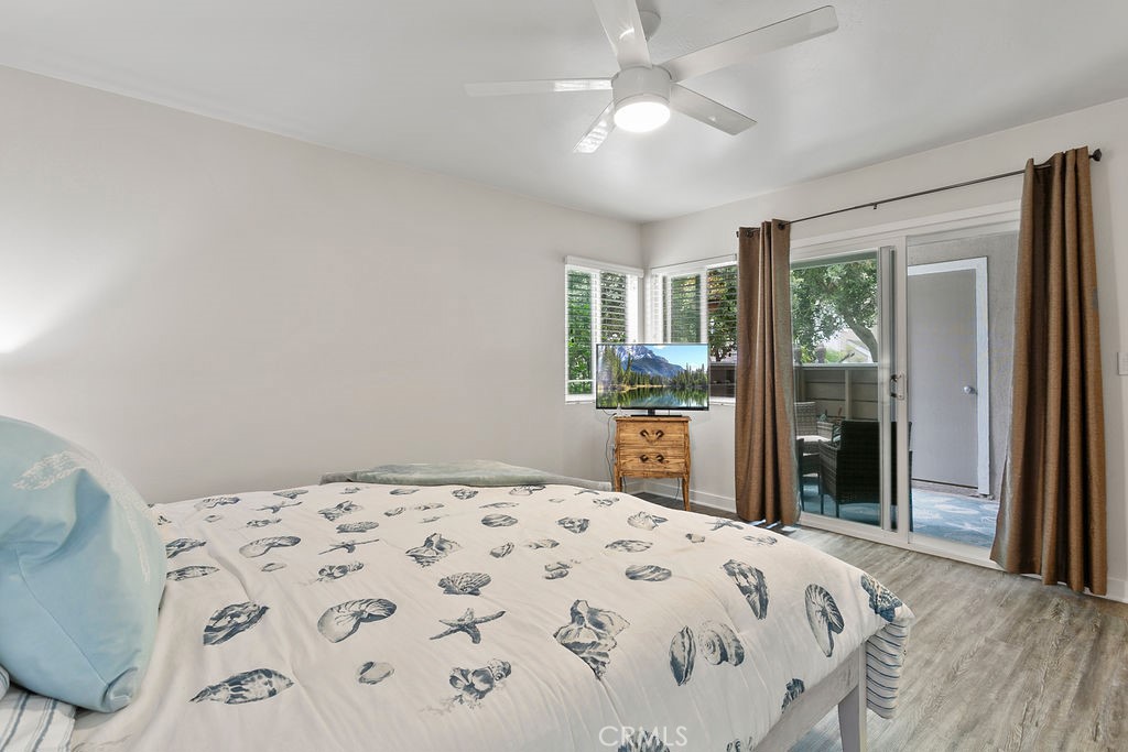 34110 Selva Road, Unit 328 Dana Point, CA 92629 - Photo 15 of 33 a bedroom with a large bed and a chandelier