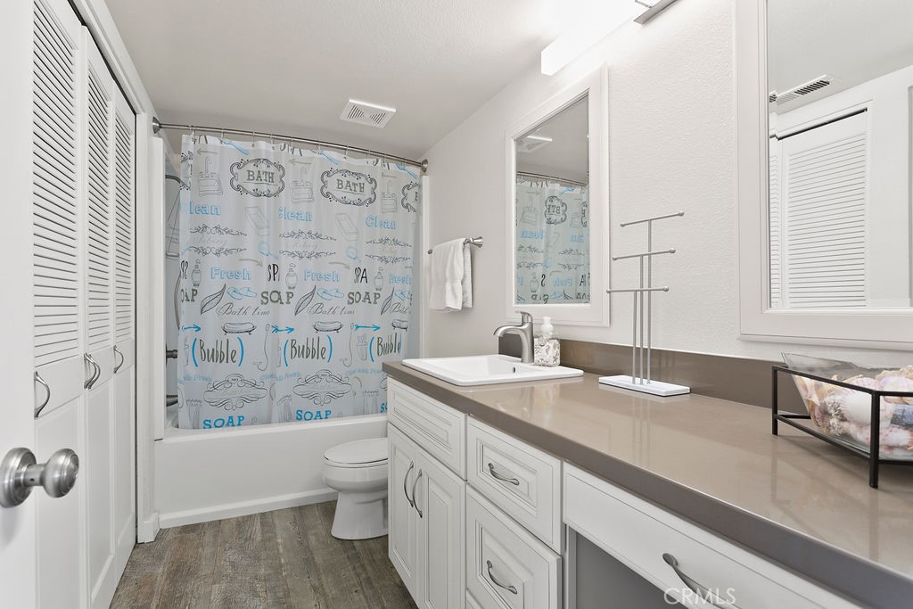 34110 Selva Road, Unit 328 Dana Point, CA 92629 - Photo 20 of 33 a spacious bathroom with a granite countertop sink a toilet a mirror a vanity and shower