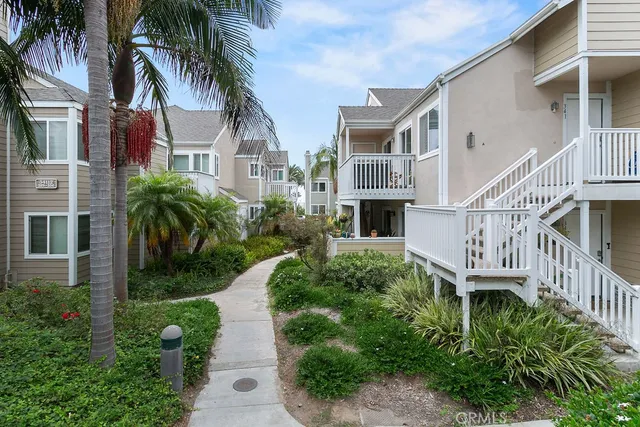 a front view of a house with a garden and plants