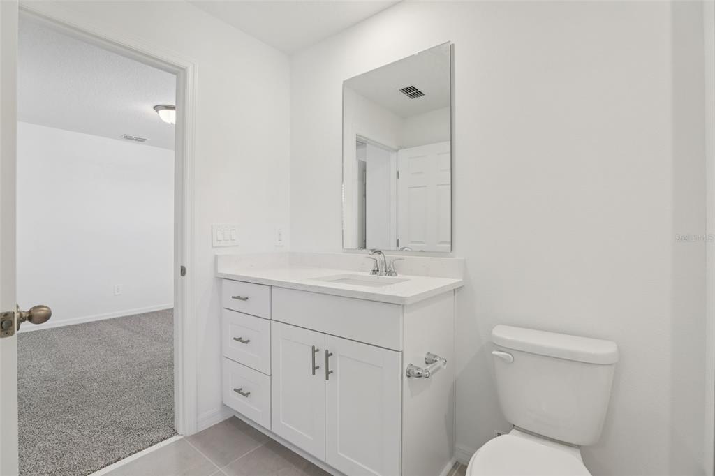 4264 Ranch House Road St. Cloud, FL 34772 - Photo 62 of 74 a bathroom with a toilet sink and mirror