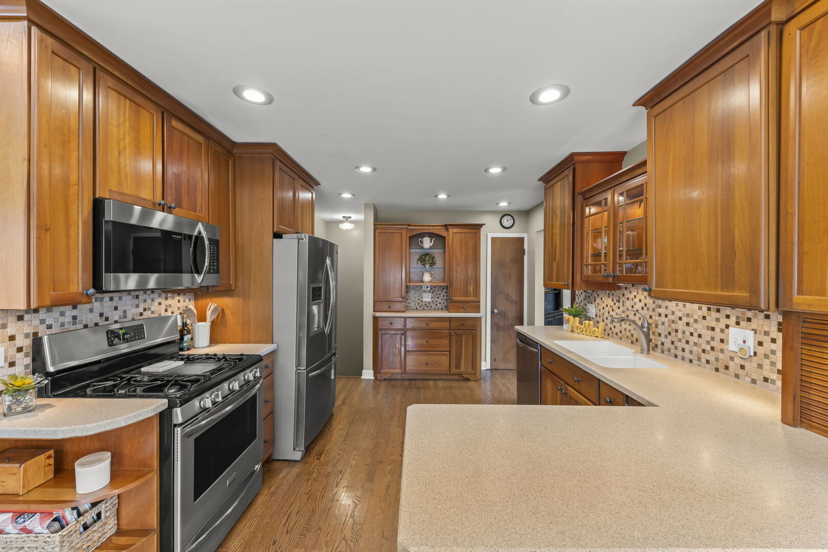 904 Gamon Road Wheaton, IL 60189 - Photo 11 of 47 a large kitchen with stainless steel appliances a large counter top a stove and a refrigerator