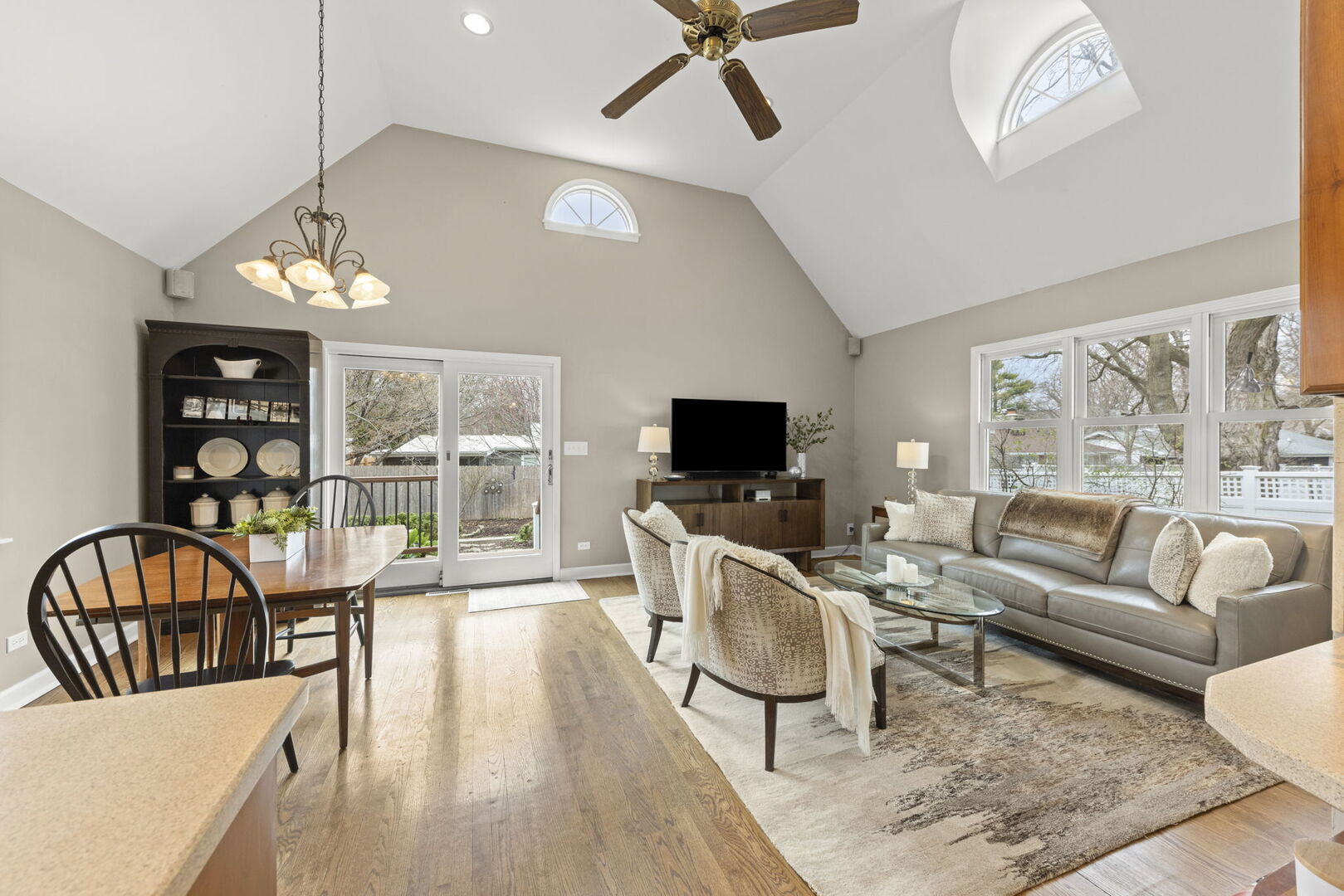 904 Gamon Road Wheaton, IL 60189 - Photo 12 of 47 a living room with furniture a flat screen tv and a floor to ceiling window
