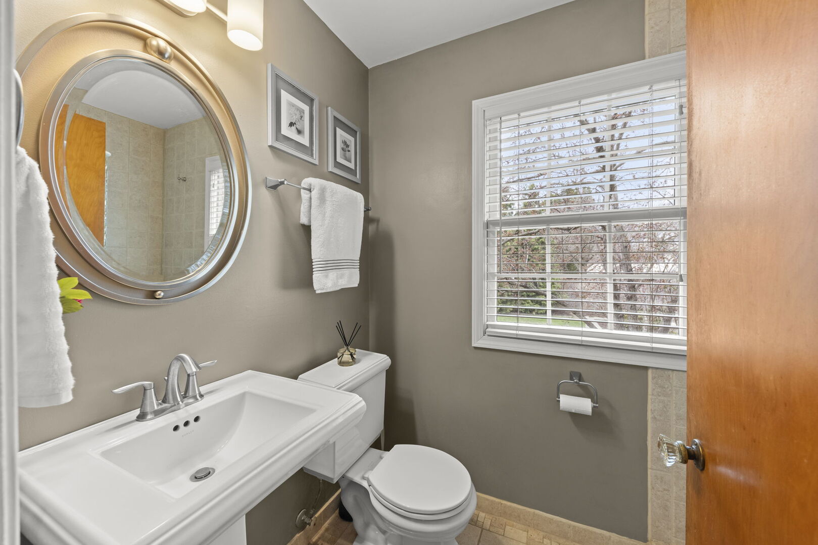904 Gamon Road Wheaton, IL 60189 - Photo 17 of 47 a bathroom with a sink a mirror a toilet and a window