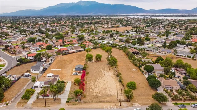 an aerial view of residential house with parking and yard