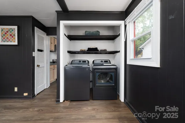 a kitchen with a stove and a wooden floor