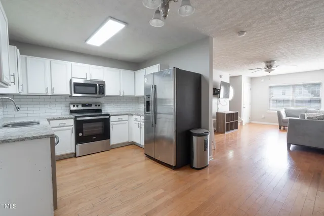 a kitchen with a refrigerator a stove top oven a sink and dishwasher