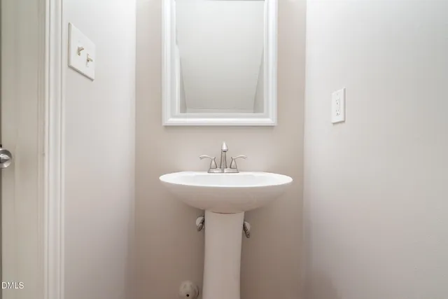 a bathroom with a sink a mirror and a toilet