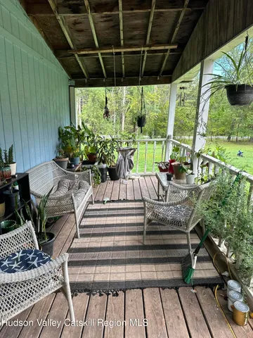 a view of a chair and table in backyard of the house