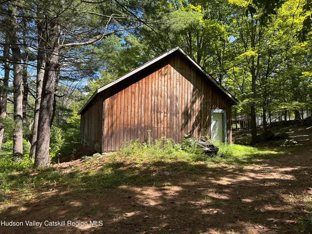 a view of outdoor space with seating area and trees around