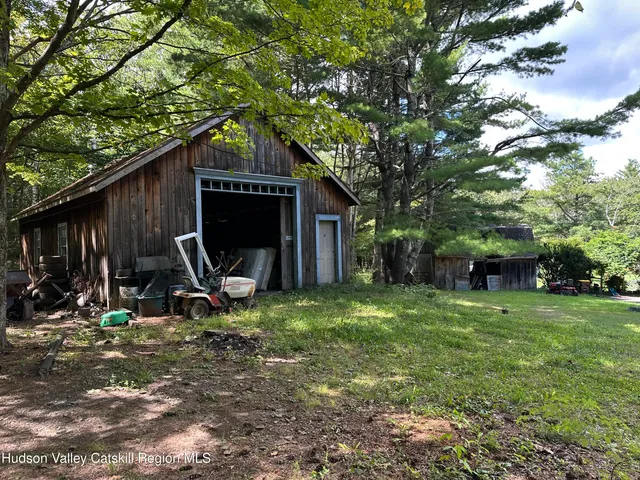 a bedroom with a bed a mirror and dresser
