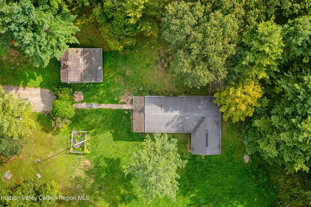 an aerial view of a house with a yard basket ball court and outdoor seating