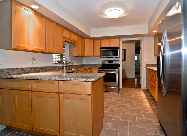 3742 Poplar Road Flossmoor, IL 60422 - Photo 10 of 20 a kitchen with stainless steel appliances granite countertop a stove a sink a microwave and refrigerator