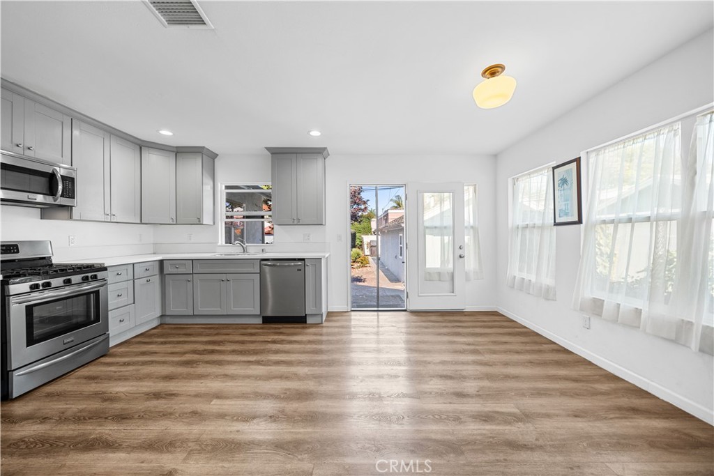 202 Mira Mar Avenue Long Beach, CA 90803 - Photo 13 of 49 a kitchen with stainless steel appliances granite countertop a stove and a sink