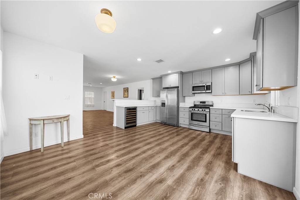 202 Mira Mar Avenue Long Beach, CA 90803 - Photo 15 of 49 a kitchen with stainless steel appliances granite countertop a refrigerator sink and cabinets