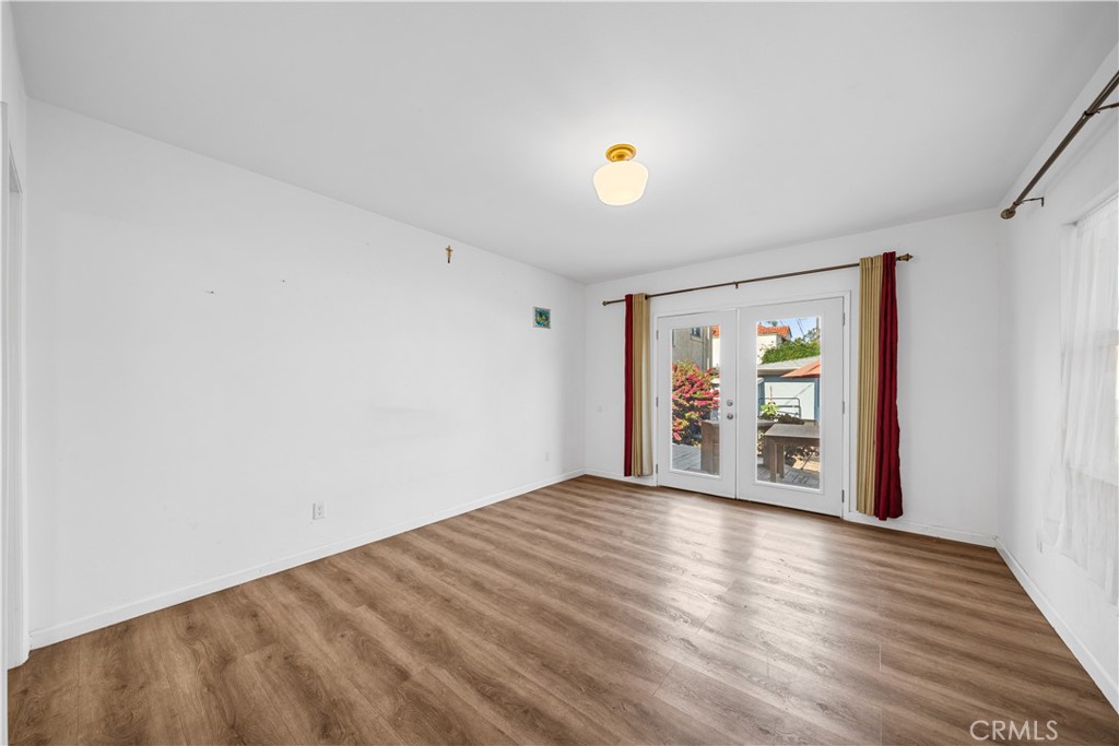202 Mira Mar Avenue Long Beach, CA 90803 - Photo 22 of 49 a view of an empty room with wooden floor and a window