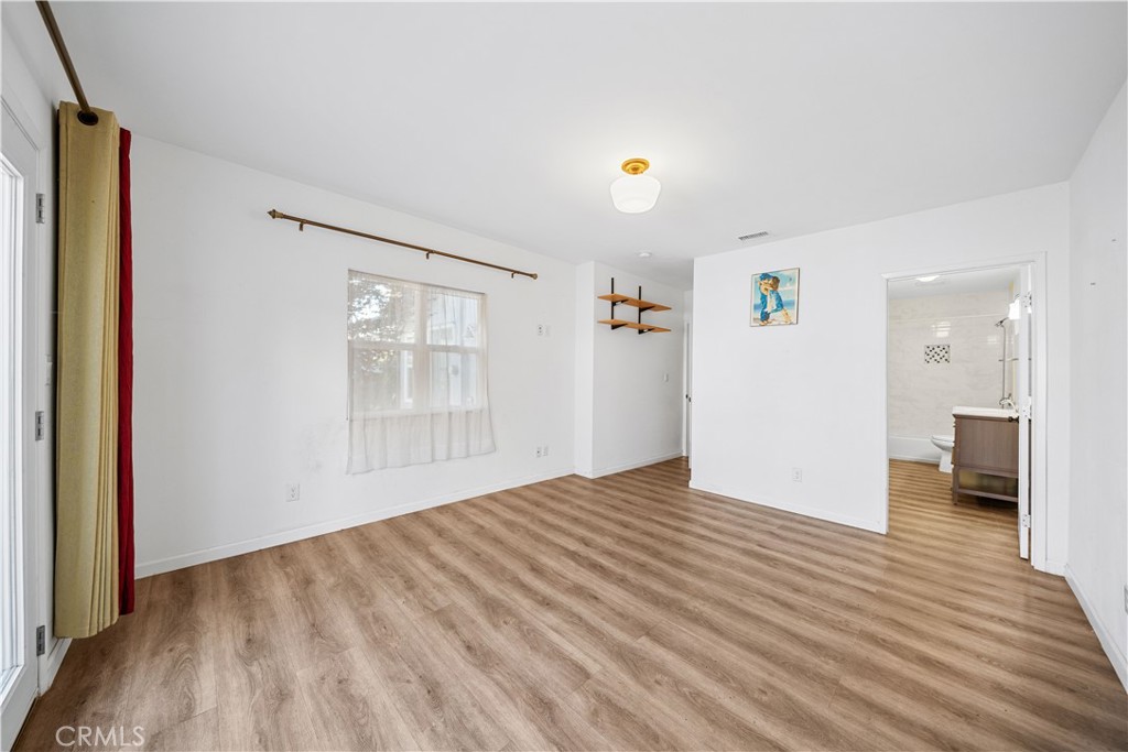 202 Mira Mar Avenue Long Beach, CA 90803 - Photo 23 of 49 a view of an empty room with wooden floor and a window