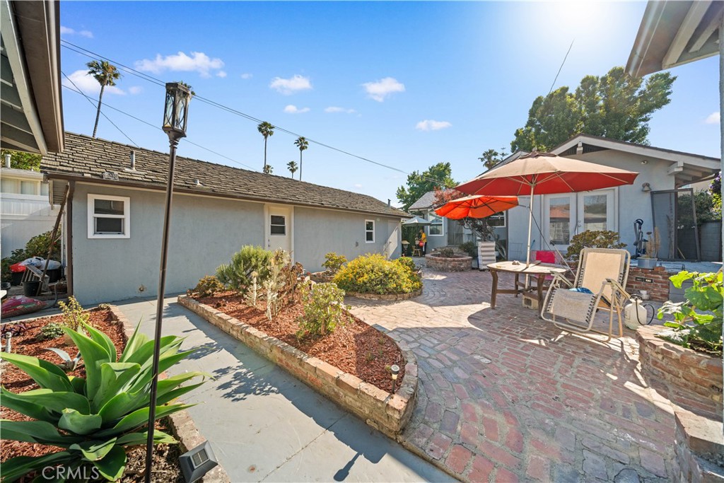 202 Mira Mar Avenue Long Beach, CA 90803 - Photo 29 of 49 a view of a patio with a table and chairs under an umbrella