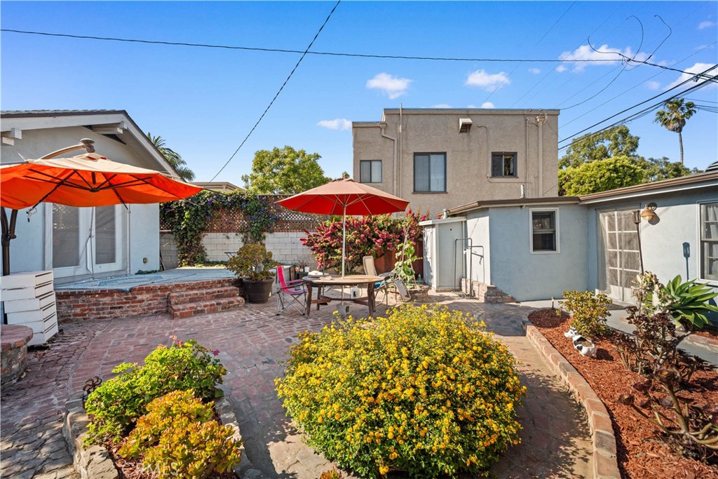 202 Mira Mar Avenue Long Beach, CA 90803 - Photo 31 of 49 a view of a patio with table and chairs under an umbrella