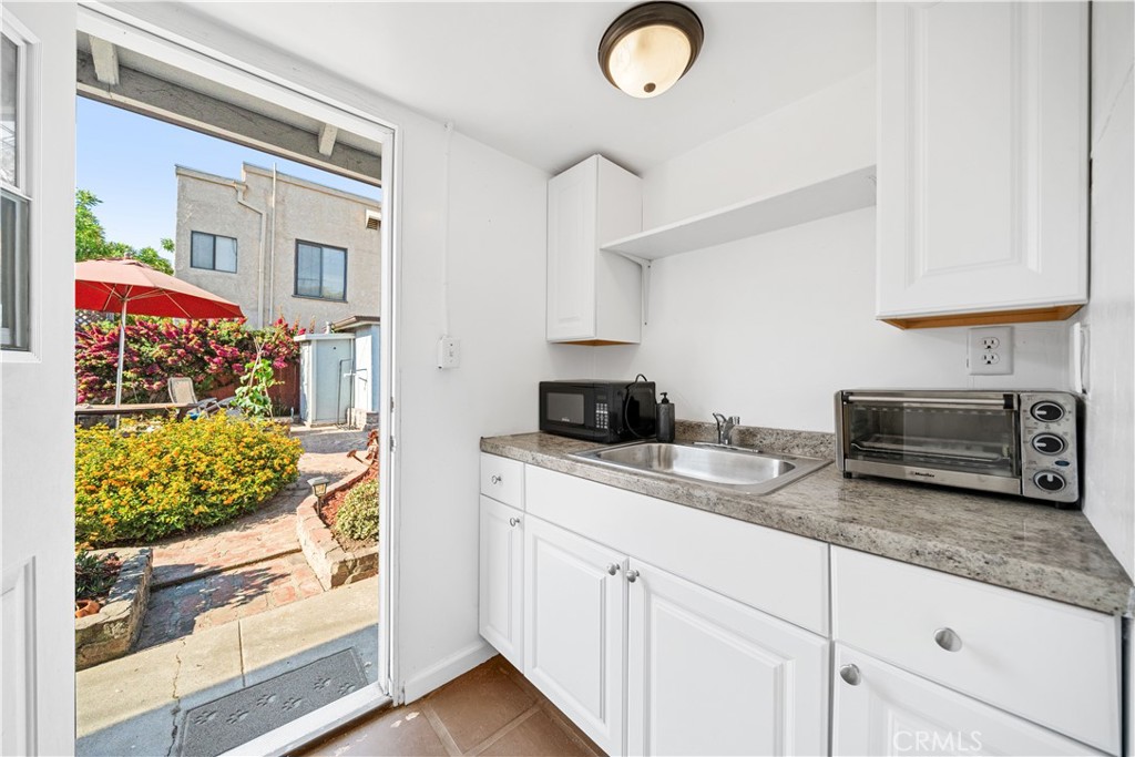 202 Mira Mar Avenue Long Beach, CA 90803 - Photo 33 of 49 a kitchen with stainless steel appliances granite countertop a sink and a white cabinets