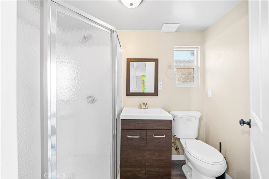 202 Mira Mar Avenue Long Beach, CA 90803 - Photo 36 of 49 a bathroom with a toilet a sink and mirror