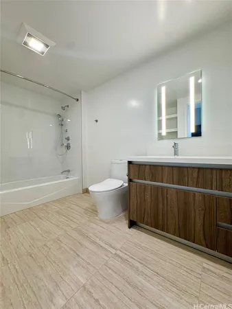 a bathroom with a sink mirror toilet and shower