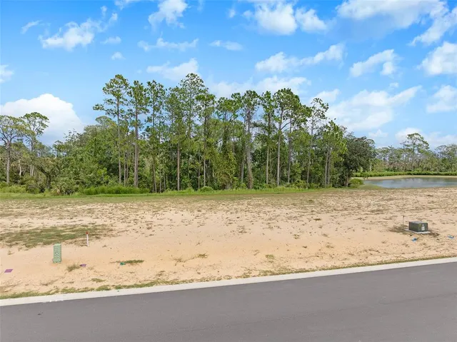 a view of a yard with wooden fence