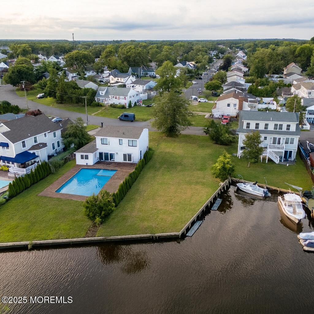 an aerial view of residential houses with outdoor space and swimming pool