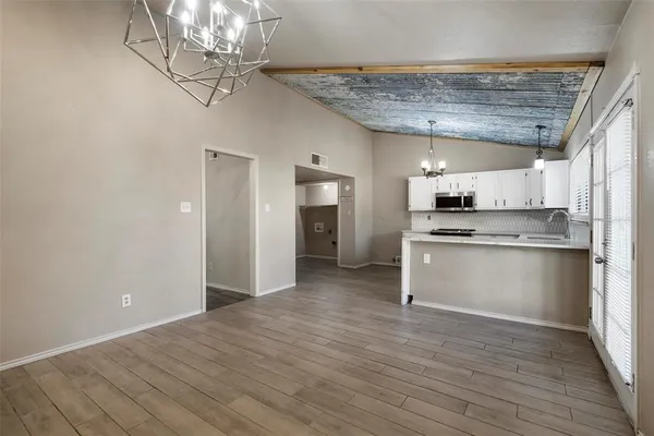 a view of kitchen with granite countertop cabinets and stainless steel appliances