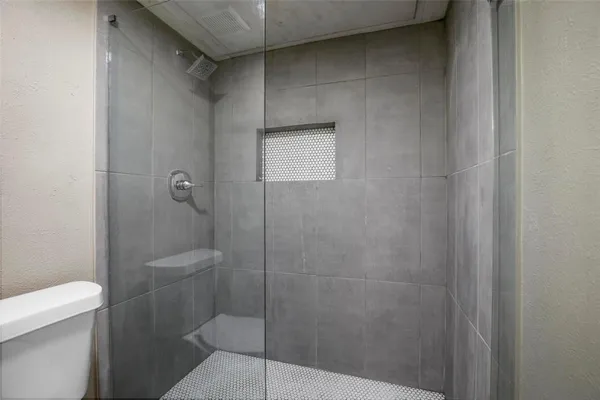 a bathroom with a shower and toilet
