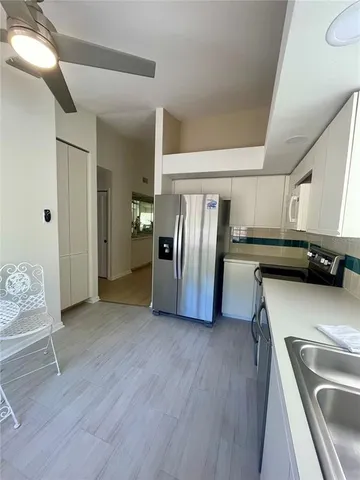 a kitchen with stainless steel appliances a refrigerator and a sink