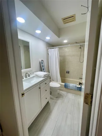 a bathroom with a double vanity sink toilet and shower