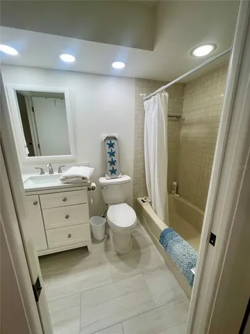 a bathroom with a sink a toilet a mirror and shower
