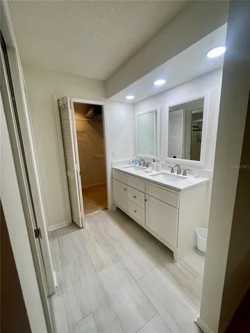 a bathroom with a double vanity sink and mirror