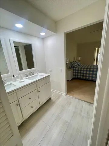 a bathroom with a double vanity sink and mirror