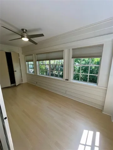a view of an empty room with a fireplace and a window