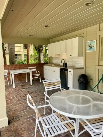 a kitchen with stainless steel appliances granite countertop a sink and wooden cabinets