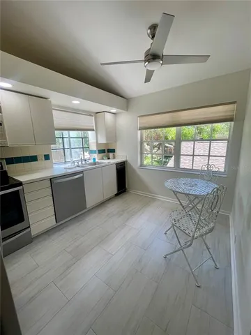 a kitchen with stainless steel appliances kitchen island granite countertop a stove a sink and a refrigerator