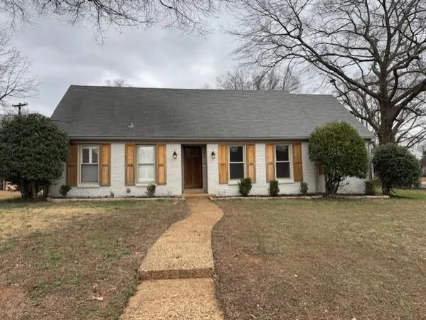 front view of a house with a garden