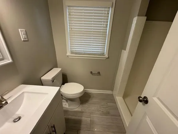 a white toilet sitting next to a sink