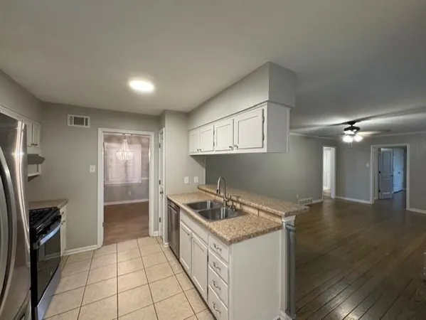 a kitchen that has a sink a stove and a refrigerator