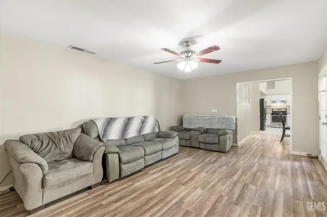 a living room with furniture and wooden floor