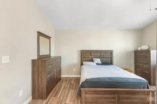 a bedroom with a bed and dresser