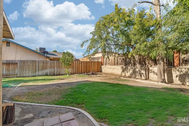 a backyard of a house with table and chairs