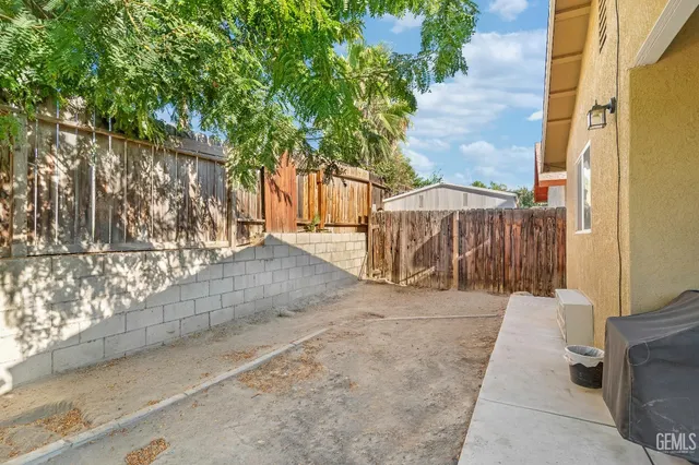 a view of a pathway with a wrought fence