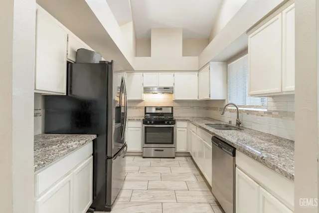 a kitchen with a sink stove and refrigerator